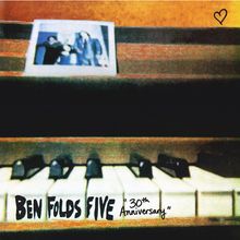 "Ben Folds Five" und "30th Anniversary" auf verwischten Klaviertasten. Ein unscharfes Foto oben, Herzsymbol in der Ecke.