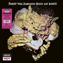 Text oben: "Barbed Wire Sandwich Black Cat Bones". Illustration eines grotesken Wesens, das ein Sandwich isst.