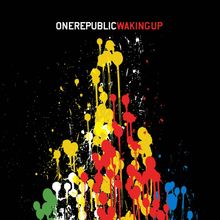 Text: "ONEREPUBLIC WAKING UP". Illustration mit bunten Farbspritzern auf schwarzem Hintergrund.