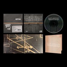 Text: "Glen Hansard Don't Settle Vol. 2 Transmissions West." CD-Hülle und CD, dunkles Design mit Linien und Pfeilen.