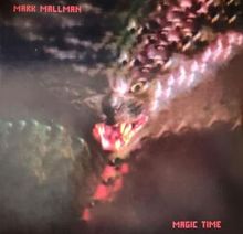 "MARK MALLMAN" und "MAGIC TIME" in roter Schrift. Ein verschwommenes, bedrohliches Wesen mit offenem Maul.