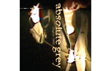 Text: "absolute grey", "cbgb's 1985". Unscharfes, farbig verzerrtes Bild einer Person mit Mikrofon in der Hand.