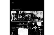 Text: "Elephant's Memory, Take It to The Streets." Schwarzweiße Konzertaufnahme mit Musikern auf einer Bühne.