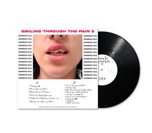 „SMILING THROUGH THE PAIN 3“ in Pink, „SWIMMING PAUL“ wiederholt. Cover zeigt Gesicht mit leicht geöffnetem Mund.