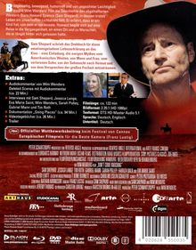 Text: "Extras: Audiokommentar, Deleted Scenes, Interviews, Doku 'Looking for Places', Making of, Trailer."  
Ein Mann mit Hut auf rotem Hintergrund.