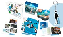 Der Text beschreibt ein Set aus einem Animationsfilm mit Artcards, Wendeposter, Metall-Card, Schlüsselanhänger und Booklet.