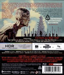 Ein Gesicht in seitlicher Ansicht, vernarbt. "Extras auf Blu-ray" in roter Schrift, darunter Featurettes und technische Details.
