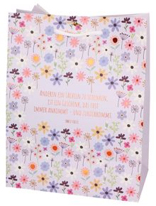 "Anderen ein Lächeln zu schenken... kommt." Zitat von Ernst Ferstl. 
Blumenmuster auf hellviolettem Hintergrund. 