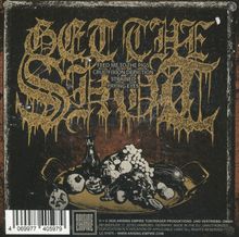 "GET THE SHOT" in goldener Schrift, darunter Songtitel. Illustration eines Stilllebens mit Obst und Totenkopf.