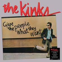 „Give the people What they Want“ steht an einer Wand. Ein Mann in Anzug und Sonnenbrille läuft davor. Oben: „the Kinks“.