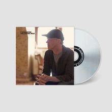 Text: "J Schlueter The Other Mile". Ein Mann mit Baseballkappe sitzt nachdenklich. Eine CD liegt daneben.
