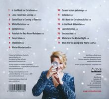 Eine Titelliste mit 17 weihnachtlichen Liedern und eine blonde Frau hält eine Schneekugel und lächelt. 