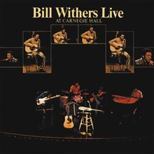 "Bill Withers Live at Carnegie Hall" in gelber Schrift. Mehrere kleine Fotos von Bill Withers mit Gitarre oben, Band unten.