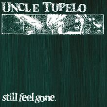 "UNCLE TUPELO" oben, "still feel gone." unten, dazwischen abstrakte Zeichnung von Händen auf dunklem Hintergrund.