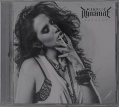 KISSIN' DYNAMITE, ECSTASY; Frau mit lockigen Haaren, raucht, trägt ein Top, Armband und Ketten.