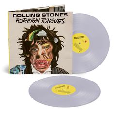 Texte: "ROLLING STONES", "FOREIGN TONGUES". Illustration eines karikaturhaften Gesichts mit verzerrten Zügen.
