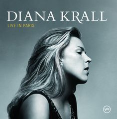 "Diana Krall, Live in Paris" – Profil einer Frau mit geschlossenen Augen und wehenden Haaren vor grauem Hintergrund.