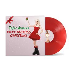 "Taylor Momsen's Pretty Reckless Christmas" in festlicher Schrift. Eine Frau in rotem Kleid, roter runde Schallplatte.
