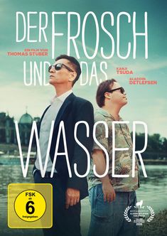 „Der Frosch und das Wasser“, zwei Männer tragen Sonnenbrillen, einer im Anzug, der andere mit einem Hawaii-Hemd.