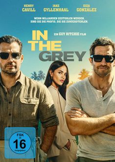 Text: "Henry Cavill", "Jake Gyllenhaal", "Eiza González", "Wenn Milliarden gestohlen werden...", "IN THE GREY", "Ein Guy Ritchie Film", "Vorab-Cover", "FSK ab 16 freigegeben". 

Zwei Männer in Sonnenbrillen und eine Frau im Hintergrund, Palmen im Hintergrund.