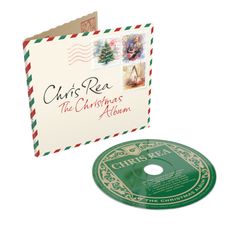 "Chris Rea: The Christmas Album" auf Cover und CD. Zwei Briefmarken zeigen einen Weihnachtsbaum und einen Gitarrenspieler.