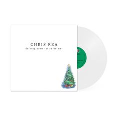 Text: "Chris Rea driving home for Christmas". Illustration: Ein geschmückter Weihnachtsbaum rechts unten. weiße Vinylplatte sichtbar.