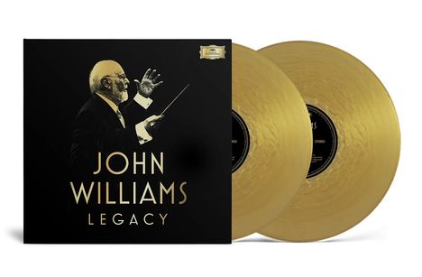 "John Williams Legacy" in goldener Schrift auf schwarzem Hintergrund. Darunter ein Dirigent mit Taktstock, zwei goldene Schallplatten.