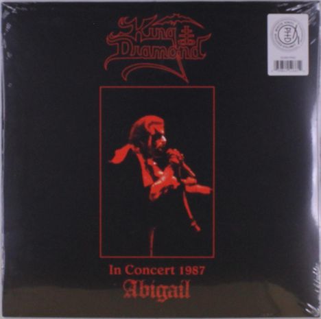 „King Diamond“, „In Concert 1987“, „Abigail“. Ein rotes Foto zeigt eine Person, die in ein Mikrofon singt.