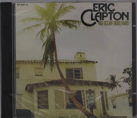 "ERIC CLAPTON 461 OCEAN BOULEVARD" steht oben rechts. Ein Haus mit Palmen und eine Person lehnt an einem Baum.