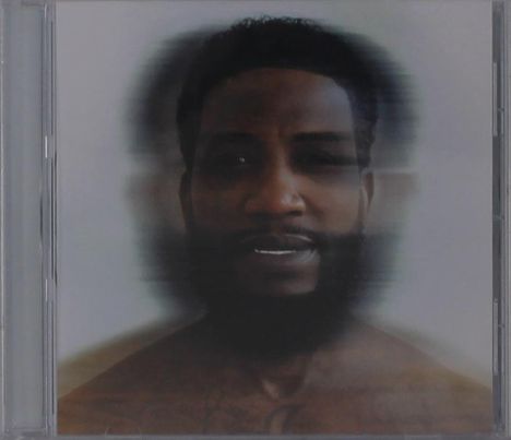 Ein unscharfes Porträt eines Mannes mit Bart, mehrfach versetzt. Das Bild erzeugt einen verschwommenen Effekt.