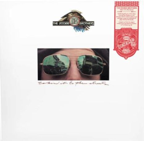 "The Doobie Brothers" oben, "Takin’ it to the Streets" darunter. Ein Gesicht mit Sonnenbrille; Gebäude spiegeln sich.