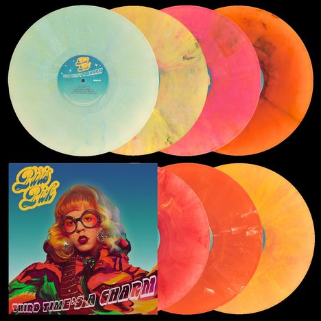 Künstlername und Titel: "Third Time's a Charm". Neonfarbenes Schallplattenset und Cover mit bunter, stilisierter Person.