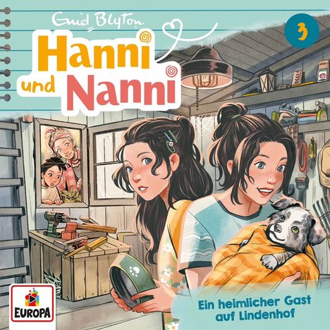 „Hanni und Nanni“, Nummer 3, „Ein heimlicher Gast auf Lindenhof“. Illustration: zwei Mädchen, ein Welpe in einer Werkstatt.