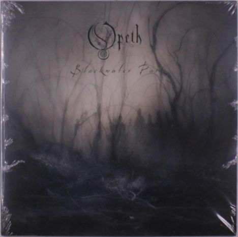 Logo "Opeth", darunter "Blackwater Park". Dunkles, nebliges Waldmotiv mit Silhouetten von Bäumen und Schatten.