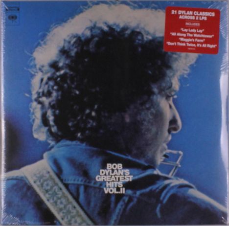 Text: „21 Dylan Classics Across 2 LPs“, „Bob Dylan's Greatest Hits Vol. II“. Illustration zeigt Person von hinten mit Gitarre.