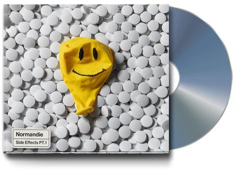 "Normandie, Side Effects PT.1". 

Ein gelber Smiley-Luftballon auf weißen Tabletten, daneben eine CD.