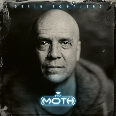 Text: "Devin Townsend" oben, "The Moth" unten. Schwarz-weiß Porträt eines ernst blickenden, glatzköpfigen Mannes.