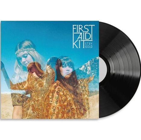 "First Aid Kit Stay Gold." Zwei Frauen in glitzernden Kleidern vor einer Bergkulisse, kombiniert mit einem Vinyl-Schallplattendesign.