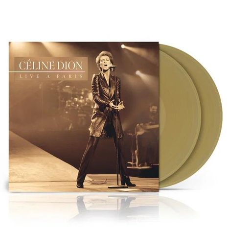 "Céline Dion Live à Paris" steht oben. Ein Bild zeigt Céline Dion singend auf der Bühne, mit Mikrofon. Zwei goldene Vinyl-Schallplatten.