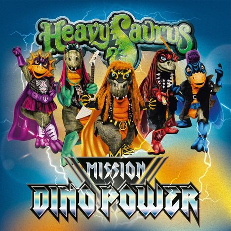 Texte: "Heavysaurus", "Mission Dino Power". Fünf bunte Dinosaurier in Rock-Outfits, Gitarren, Blitzhintergrund.