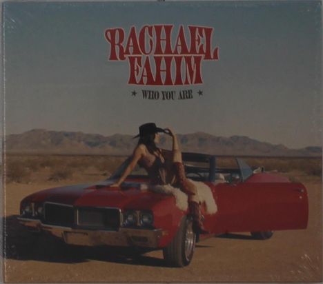 „Rachael Fahim, Who You Are“, ein rotes Auto in Wüstenlandschaft mit einer Frau, die Cowboy-Hut trägt.