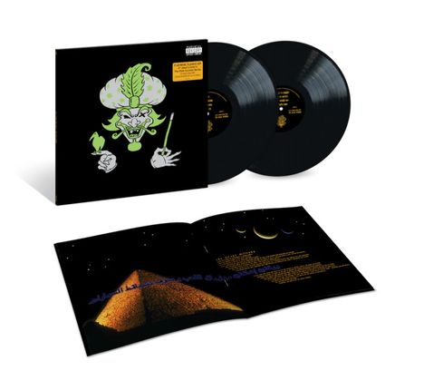 Das Bild zeigt zwei Schallplatten, ein Albumcover mit Cartoon-Figur und ein offenes Booklet mit einem Pyramidenbild.