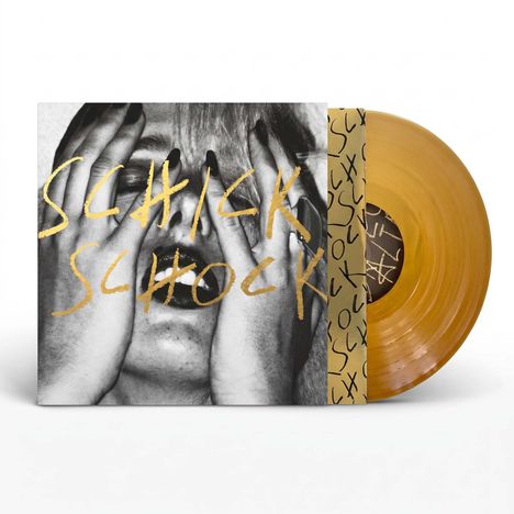 Text: "SCHICK SCHOCK" in goldener Schrift. Albumcover mit Gesicht hinter Händen. Goldene Schallplatte im Hintergrund.