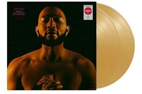 Die Aufschrift lautet "LegenD." Ein Mann, der die Hände gefaltet hält, steht vor einem dunklen Hintergrund. Zwei goldene Schallplatten.