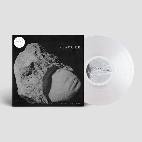 Ein schwarzes Cover mit "the CURE" und "Songs of a Lost World". Ein Gesicht in Sandstein gehauen, daneben eine transparente Schallplatte.