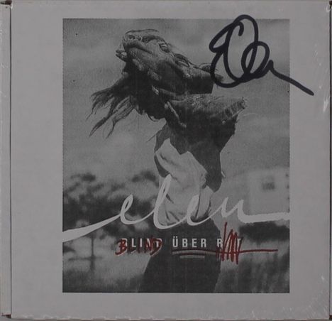 Text: "Blind über Rot." Darunter schwarz-weißes Foto einer Person mit hochgeworfenem Haar. Signatur oben rechts.