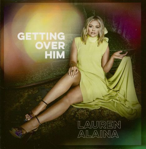 „GETTING OVER HIM“ und „LAUREN ALAINA“, Person in gelbem Kleid sitzt auf einem Sofa.