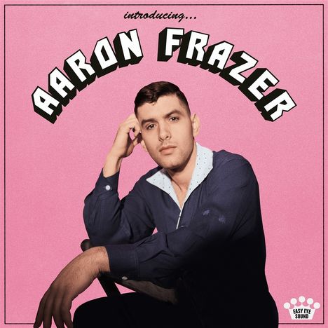 Text: "Introducing... AARON FRAZER". Ein Mann in blauer Kleidung sitzt vor einem rosa Hintergrund. Unten rechts: Easy Eye Sound Logo.