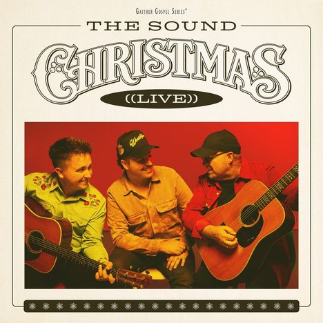 "The Sound Christmas (Live)". Drei Männer mit Gitarren, lachen, rote und gelbe Hemden, rote Hintergrundbeleuchtung.