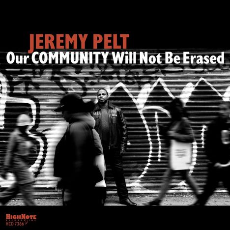 "JEREMY PELT Our COMMUNITY Will Not Be Erased." Eine Person steht vor einer mit Graffiti bedeckten Metallrolltür.